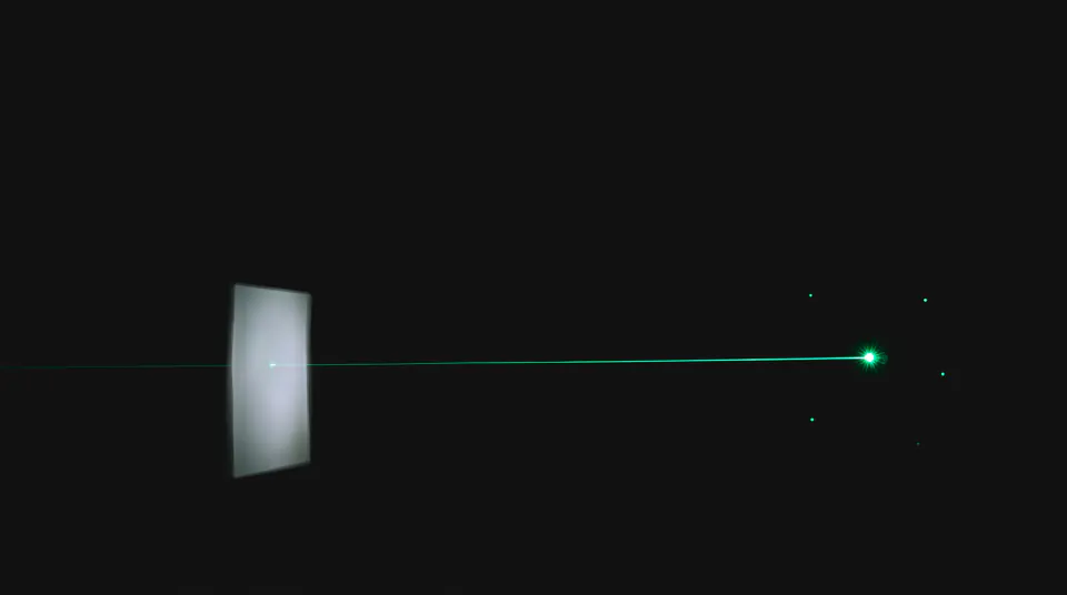 One emerald thread of light running from a bright point back to a dim glowing rectangle; nearby points with no thread fade out.