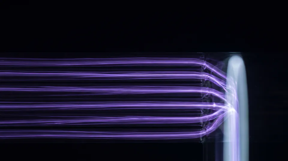 Six violet filaments of light running side by side in separate glass channels, meeting one vertical bar of light on the right.